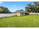 Back exterior view of home showcasing fenced-in backyard with lush lawn at 4360 Se 106Th St, Belleview, FL 34420