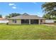 Back exterior view of home, featuring a screened-in porch and fenced backyard at 4360 Se 106Th St, Belleview, FL 34420