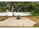 Backyard with a brick patio, fire pit, and swing, fenced for privacy at 4360 Se 106Th St, Belleview, FL 34420