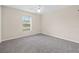 Bright bedroom with neutral walls, carpeting, and a window at 4360 Se 106Th St, Belleview, FL 34420