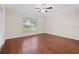 Bedroom with hardwood floors, ceiling fan, and natural light at 4360 Se 106Th St, Belleview, FL 34420