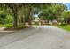 Gated community entrance with brick pillars and wrought iron gates, surrounded by lush greenery at 4360 Se 106Th St, Belleview, FL 34420