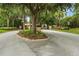 Gated community entrance featuring lush landscaping, mature trees, and a secure entrance at 4360 Se 106Th St, Belleview, FL 34420