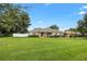 Well-kept single story home with a lush lawn and landscape; complemented by a red front door at 4360 Se 106Th St, Belleview, FL 34420