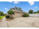 Angle view of a three car garage with large driveway and mature landscaping at 4360 Se 106Th St, Belleview, FL 34420