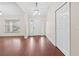 Spacious living room with wood floors, ample natural light, and a view of the front door at 4360 Se 106Th St, Belleview, FL 34420