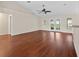 Open-plan living room with hardwood floors and French doors to the backyard at 4360 Se 106Th St, Belleview, FL 34420