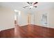Bright main bedroom featuring wood floors, a ceiling fan, and a sliding glass door to access outdoor space at 4360 Se 106Th St, Belleview, FL 34420