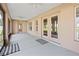 Enclosed patio features neutral walls, ceiling fans, screened windows, and sliding glass doors to the backyard at 4360 Se 106Th St, Belleview, FL 34420