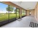 Enclosed porch featuring tile floor, ceiling fans, and views of fenced backyard at 4360 Se 106Th St, Belleview, FL 34420