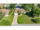 Aerial view of home with landscaped lawn, screened-in pool, and mature trees at 4555 Nw 6Th Cir, Ocala, FL 34475