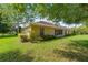 A sprawling backyard featuring mature landscaping, green lawn and the rear of the home at 4555 Nw 6Th Cir, Ocala, FL 34475
