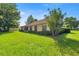 Well-maintained backyard with lush greenery surrounding the house at 4555 Nw 6Th Cir, Ocala, FL 34475