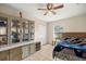 Bedroom featuring neutral walls, a ceiling fan and a display cabinet with drawers at 4555 Nw 6Th Cir, Ocala, FL 34475