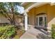 Close up of the home's front entrance, featuring a decorative column and glass paneled door at 4555 Nw 6Th Cir, Ocala, FL 34475