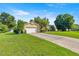 Ranch style home with lush green lawn and mature trees on a sunny day at 4555 Nw 6Th Cir, Ocala, FL 34475