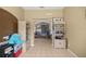 Hallway showing shelves, tile floor and an archway leading to another room at 4555 Nw 6Th Cir, Ocala, FL 34475