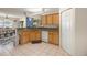 Bright kitchen features granite countertops, natural wood cabinets and white appliances at 4555 Nw 6Th Cir, Ocala, FL 34475