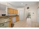 Open kitchen features wood cabinets, tile flooring, granite counters and white appliances at 4555 Nw 6Th Cir, Ocala, FL 34475