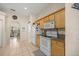 A well-lit kitchen features wood cabinets, a white stove and fridge, and granite countertops at 4555 Nw 6Th Cir, Ocala, FL 34475