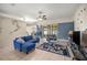 Open concept living room with tile flooring, fan, and sliding glass doors to backyard at 4555 Nw 6Th Cir, Ocala, FL 34475