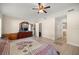 Large primary bedroom with a ceiling fan, attached bathroom and large dresser at 4555 Nw 6Th Cir, Ocala, FL 34475