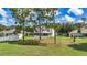Spacious backyard featuring lush green grass and mature pine trees offering a tranquil outdoor space at 4602 Se 28Th St, Ocala, FL 34480
