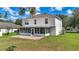 Backyard with screen lanai and brick patio, providing a comfortable and stylish outdoor space for leisure at 4602 Se 28Th St, Ocala, FL 34480