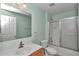 A clean bathroom includes a vanity, toilet, and shower-tub combination with sliding glass doors at 4602 Se 28Th St, Ocala, FL 34480