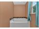 Close up of a bathtub with tile accents and a window with natural light at 4602 Se 28Th St, Ocala, FL 34480