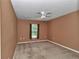 Neutral bedroom with ceiling fan, carpet floors and a single window for natural light at 4602 Se 28Th St, Ocala, FL 34480
