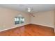 The room is bright with wood floors, a large window, and a ceiling fan for added comfort at 4602 Se 28Th St, Ocala, FL 34480