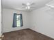 A carpeted bedroom features a ceiling fan, closet and a window offering natural light at 4602 Se 28Th St, Ocala, FL 34480