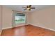 Bedroom with wood floors, neutral walls, and a window overlooking the front yard at 4602 Se 28Th St, Ocala, FL 34480