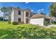 Charming two-story home with a well-manicured lawn and lush landscaping at 4602 Se 28Th St, Ocala, FL 34480