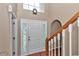 Elegant front door with decorative glass accents, complemented by a staircase and wood floors at 4602 Se 28Th St, Ocala, FL 34480