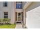 Inviting front entrance featuring a decorative glass door, manicured landscaping, and a well-lit walkway at 4602 Se 28Th St, Ocala, FL 34480