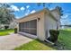 Attached garage with a screened door and mature landscaping at 4602 Se 28Th St, Ocala, FL 34480