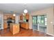 Open kitchen with stainless steel appliances, a center island, and a seamless transition to sunroom at 4602 Se 28Th St, Ocala, FL 34480