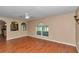 Open living room featuring wood floors, neutral walls, and views into the kitchen at 4602 Se 28Th St, Ocala, FL 34480