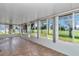 Bright sunroom with tile flooring surrounded by large windows, offering ample natural light and outdoor views at 4602 Se 28Th St, Ocala, FL 34480