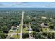 Aerial view of the property surrounded by lush greenery and other residential homes at 4661 Sw Gardenia Ct, Dunnellon, FL 34431