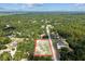 Property aerial view showcasing surrounding trees, the house, and a spacious yard enclosed at 4661 Sw Gardenia Ct, Dunnellon, FL 34431