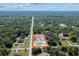 Aerial view of the property surrounded by lush greenery and other residential homes at 4661 Sw Gardenia Ct, Dunnellon, FL 34431