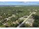 Aerial view of the community with lush tree cover and neighboring homes on a sunny day at 4661 Sw Gardenia Ct, Dunnellon, FL 34431