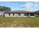Expansive backyard with lush green grass and mature trees, perfect for outdoor activities at 4661 Sw Gardenia Ct, Dunnellon, FL 34431