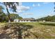 Expansive backyard featuring a large grassy area, shed, and the rear of the house at 4661 Sw Gardenia Ct, Dunnellon, FL 34431