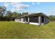 Expansive backyard with lush green grass and mature trees, perfect for outdoor activities at 4661 Sw Gardenia Ct, Dunnellon, FL 34431
