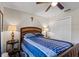 Cozy bedroom with a ceiling fan, and a blue comforter on the bed at 4661 Sw Gardenia Ct, Dunnellon, FL 34431