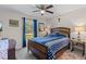 Cozy bedroom with comfortable bed, accent furniture, and view of the yard at 4661 Sw Gardenia Ct, Dunnellon, FL 34431